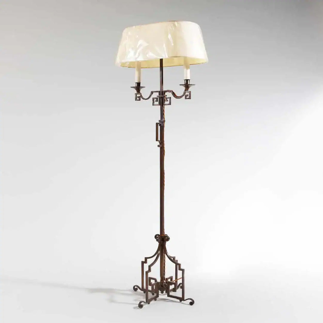 A patinated Steel floor standing bouillotte lamp with adjustable height and two shaded lights, circa 1920.