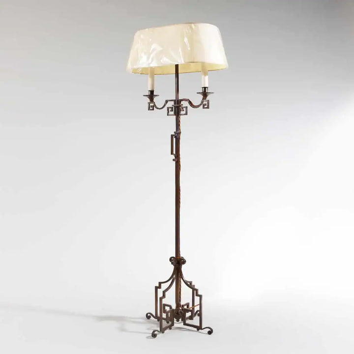 A patinated Steel floor standing bouillotte lamp with adjustable height and two shaded lights, circa 1920.