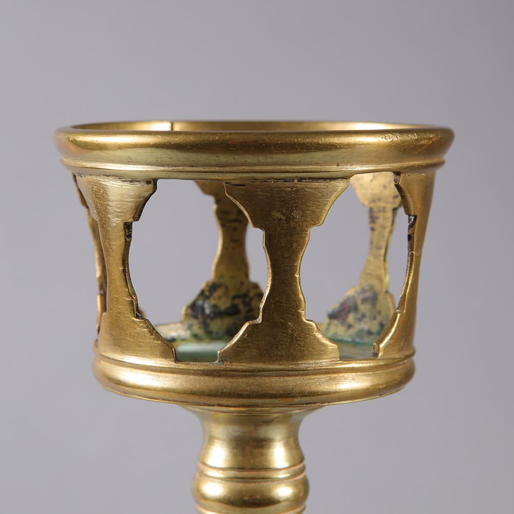 Close-up of spun brass candle stand top from Collection EE10 vintage set circa 1875 with elegant openwork design