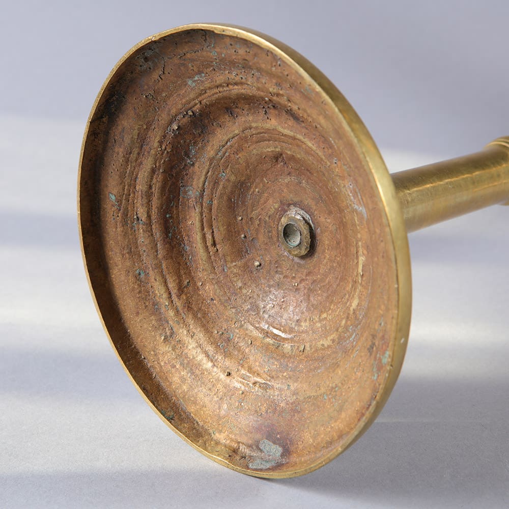 Close-up of a spun brass candle stand base from Collection EE10 with aged patina and 36 cm height circa 1875 vintage style