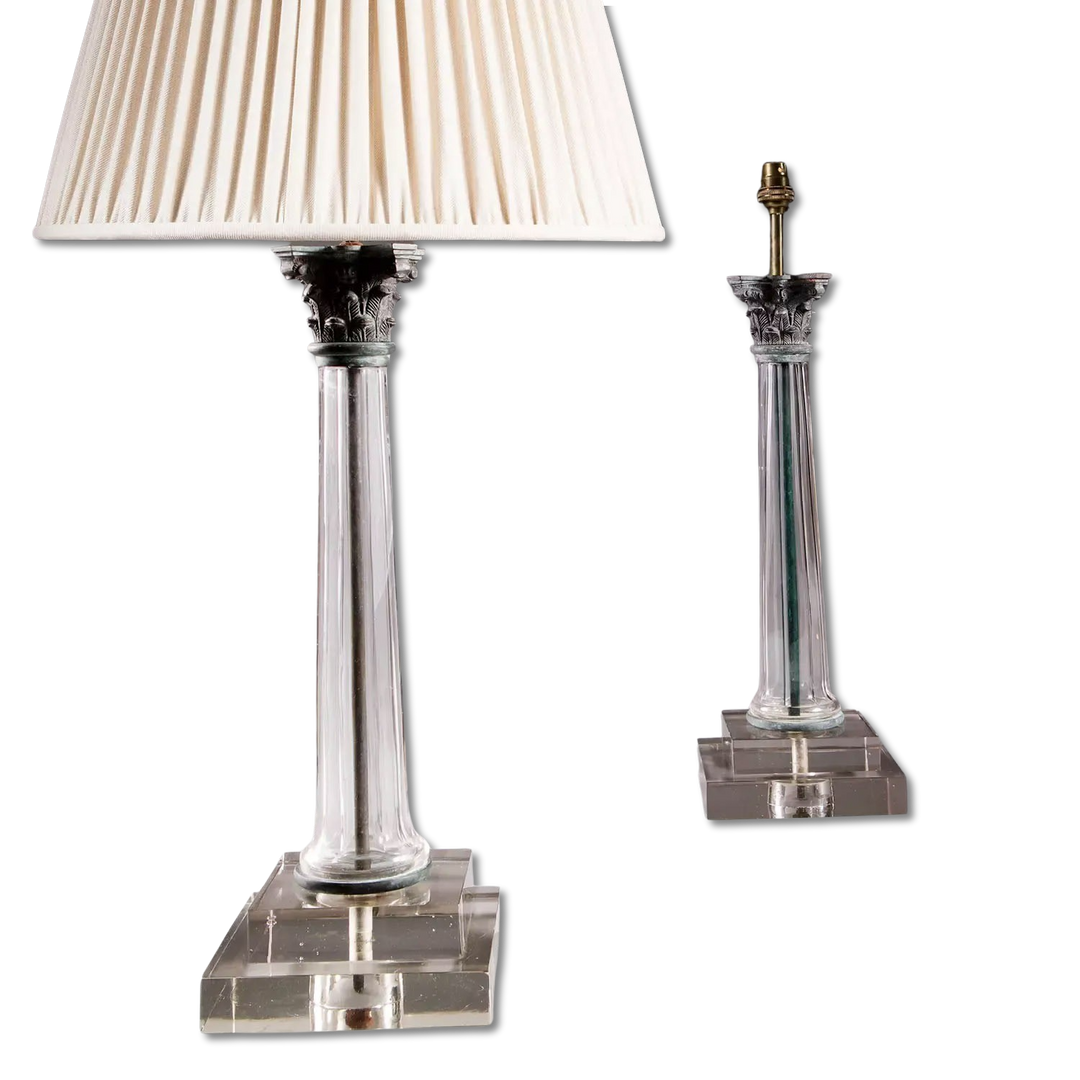 Pair of Clear Glass Faceted Column Lamps with bronze Corinthian capitals on stepped square bases, 44.5 cm tall.