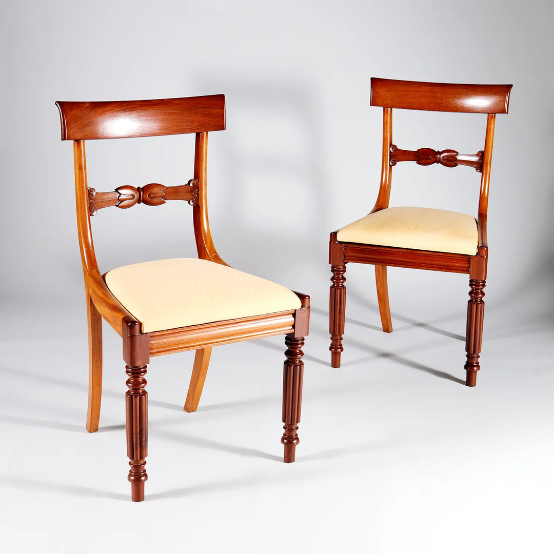 Pair of elegant William IV mahogany dining chairs with cream seats by Collection PK10 against a plain background