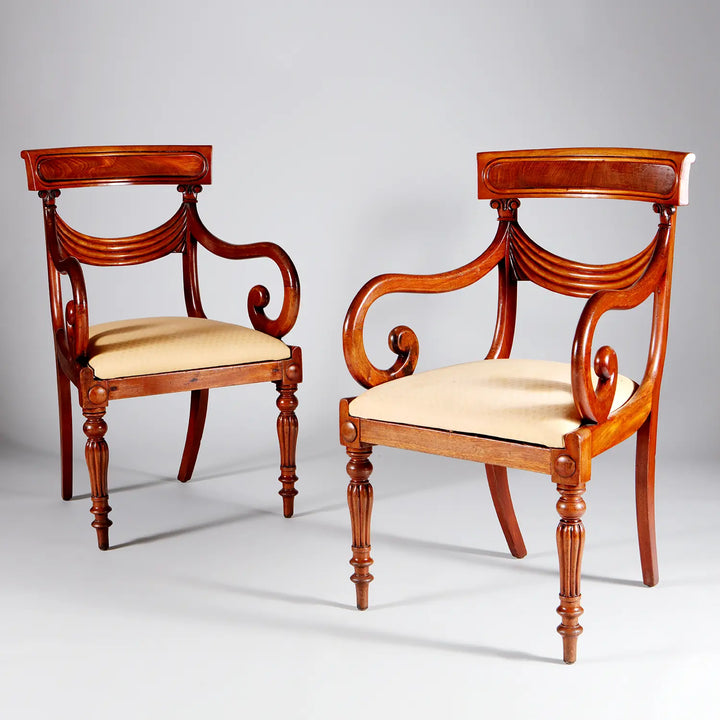 Pair of elegant William IV mahogany dining armchairs with curved backs and cream upholstered seats by Collection PK10
