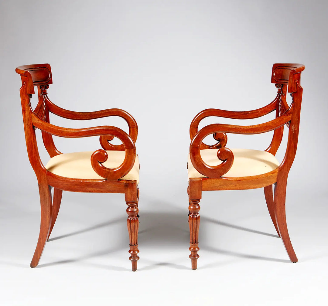 Pair of elegant William IV mahogany armchairs with curved arms and cream upholstery by Collection PK10