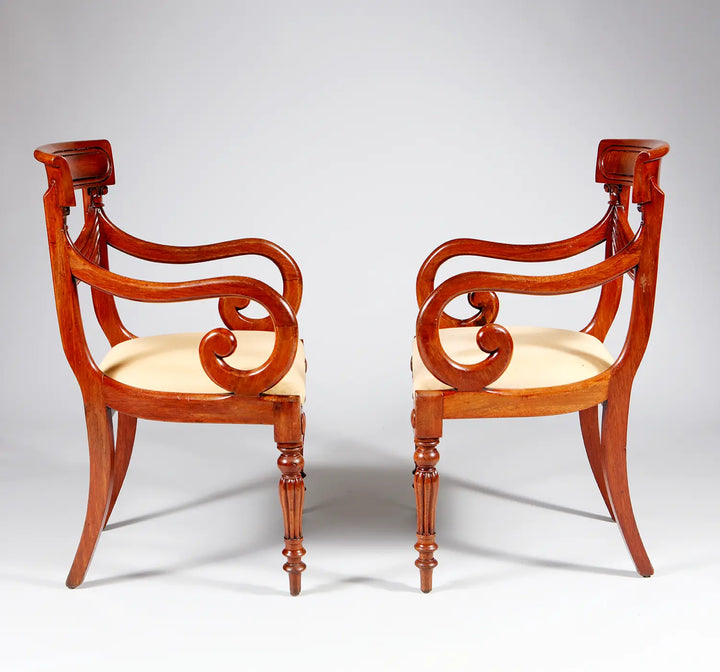 Pair of elegant William IV mahogany armchairs with curved arms and cream upholstery by Collection PK10