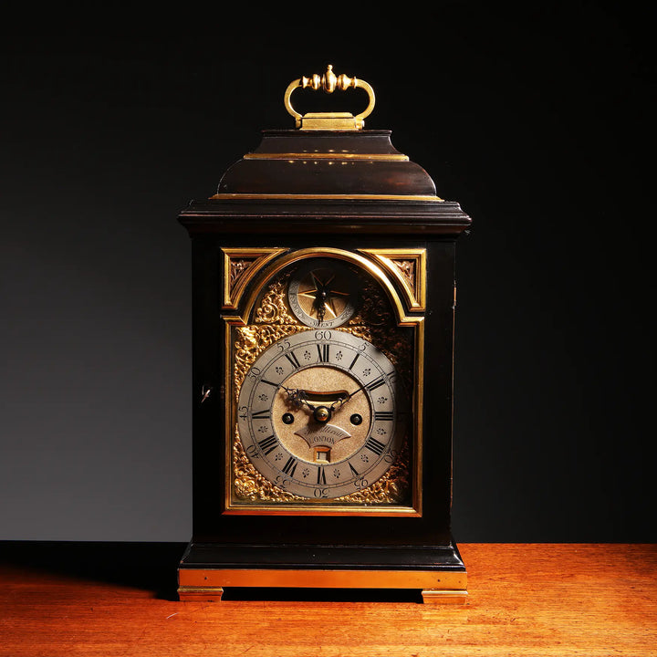 Mid 18th century ebony and gilt bronze bracket clock by John Ellicott, offered by Nwtiques.