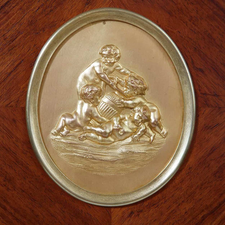 Detailed gilt bronze oval plaque with cherubs playing on a Napoleon III secretaire by Nwtiques