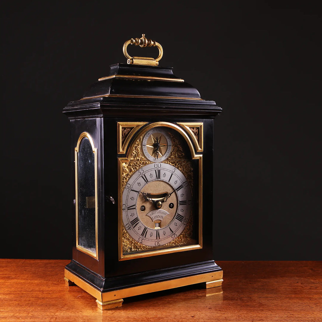 Mid 18th century ebony and gilt bronze bracket clock by John Ellicott, offered by Nwtiques.