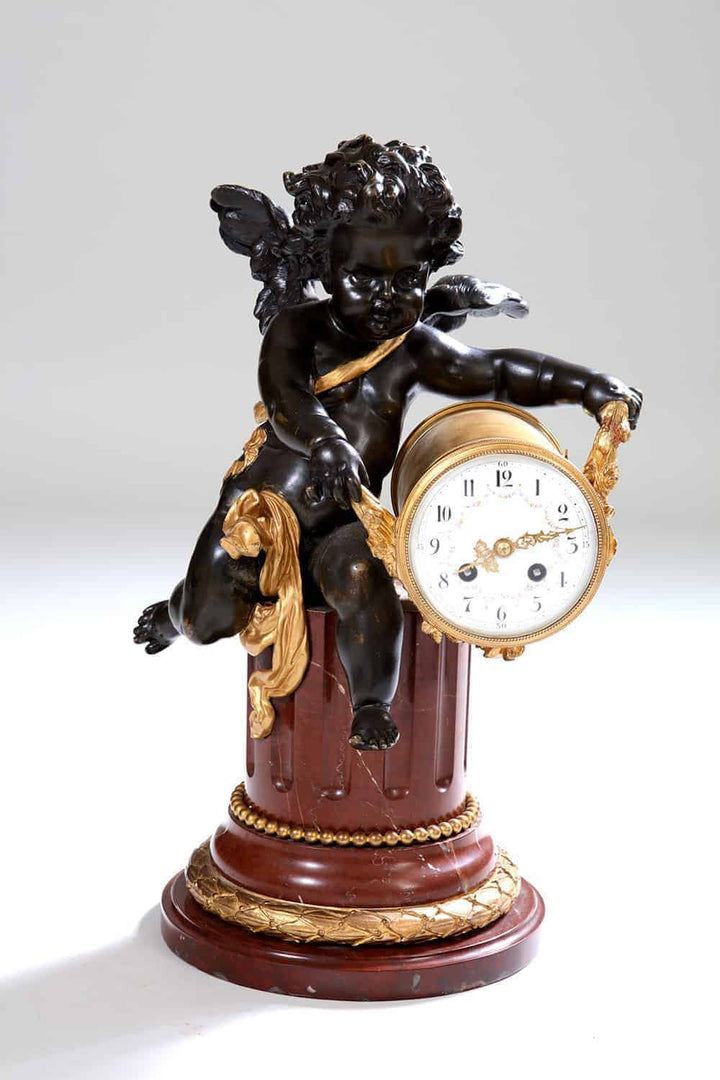 Gilt bronze cherub clock on rouge marble column with gilt accents by Nwtiques