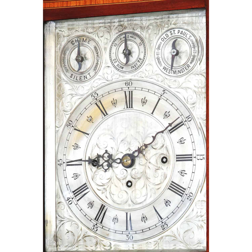 Engraved face of late 19th century marquetry bracket clock by Nwtiques showing Roman numerals and ornate hands