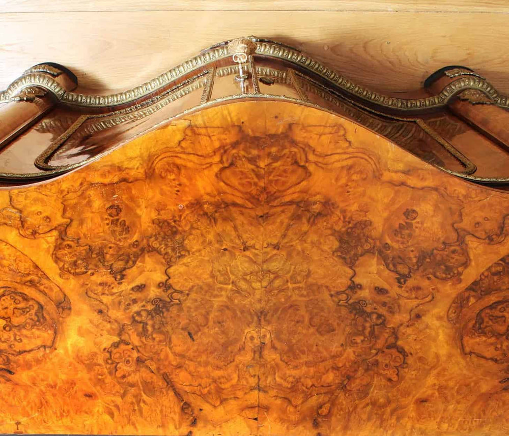 Close-up of intricate walnut marquetry and ornate ormolu mounts on antique credenza by Nwtiques