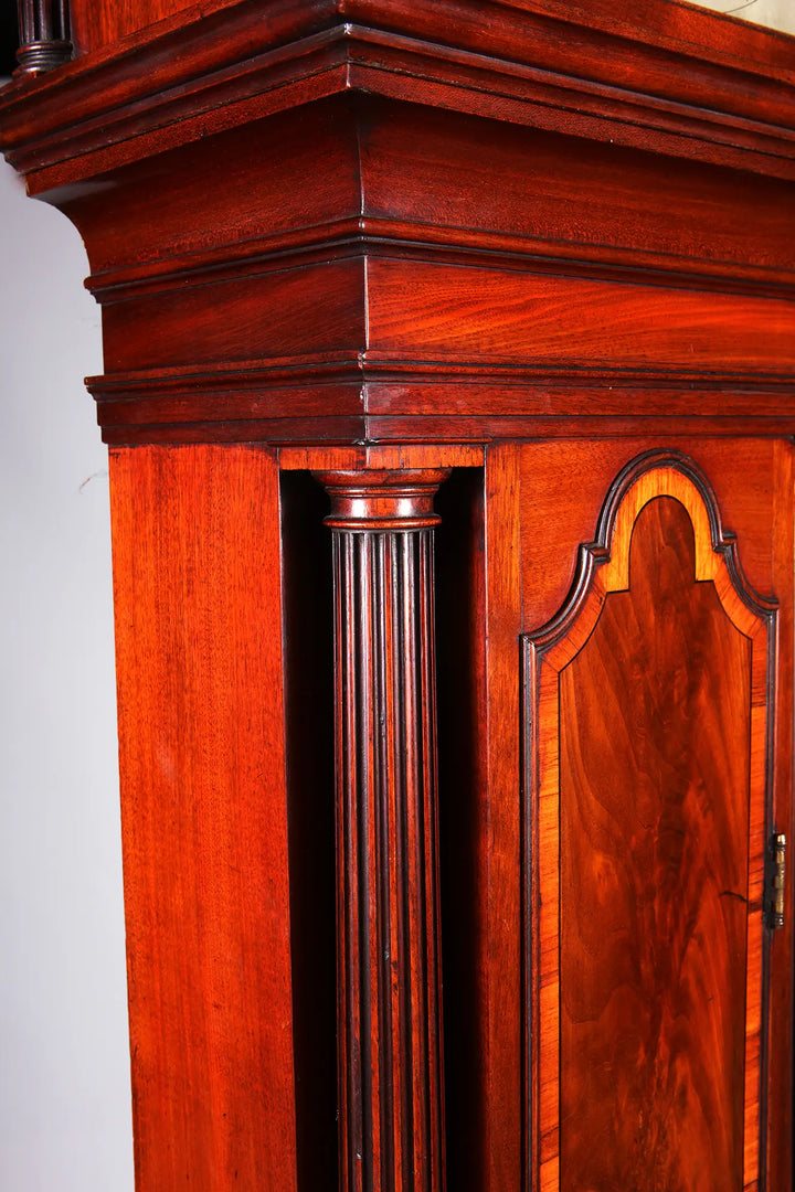 Close-up of George III mahogany longcase clock with fluted column detail by Nwtiques