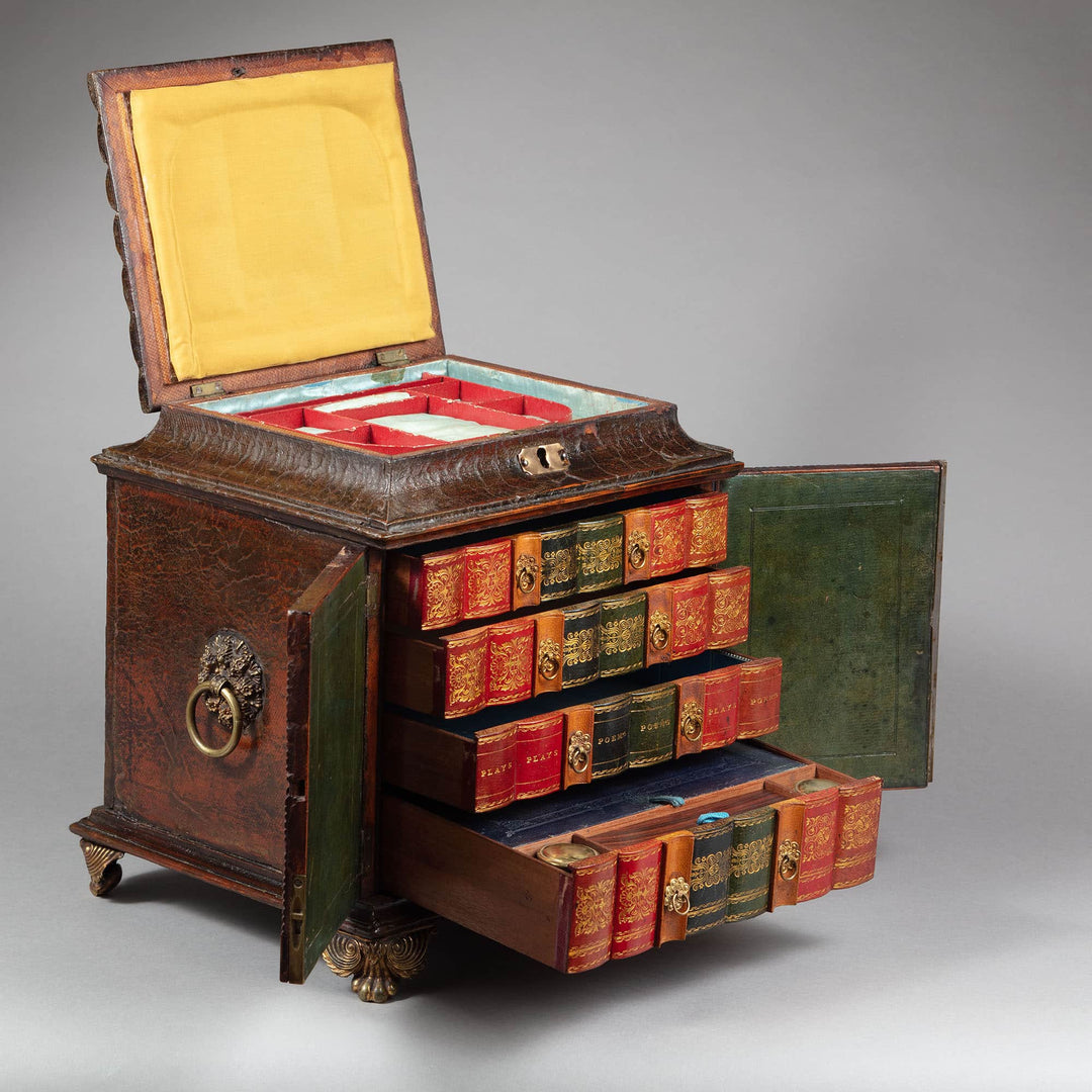 Regency leather fitted table top casket by Collection CK10 with multiple compartments and antique book design drawers