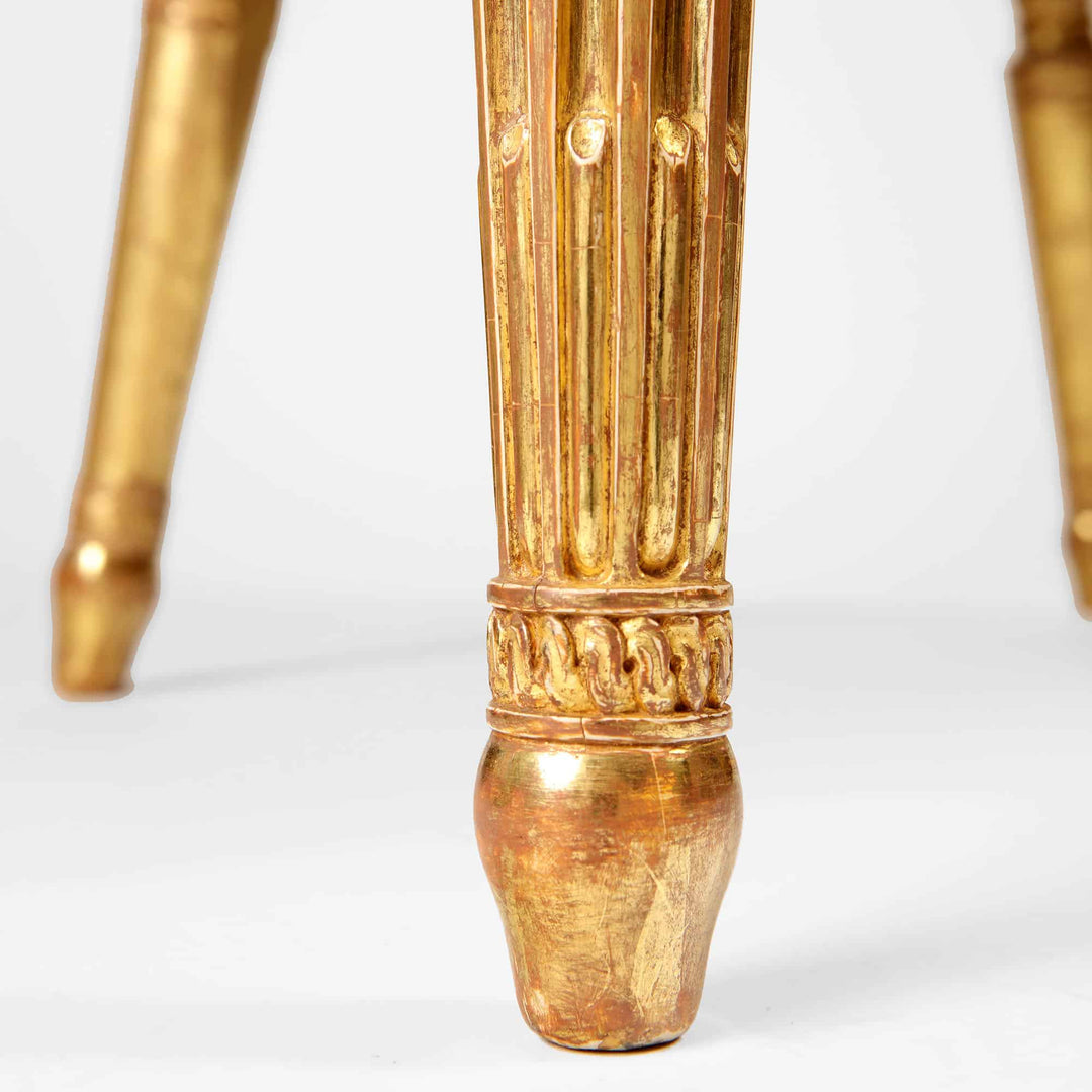 Close-up of giltwood tapered and fluted armchair leg with carved detailing by Collection CK20