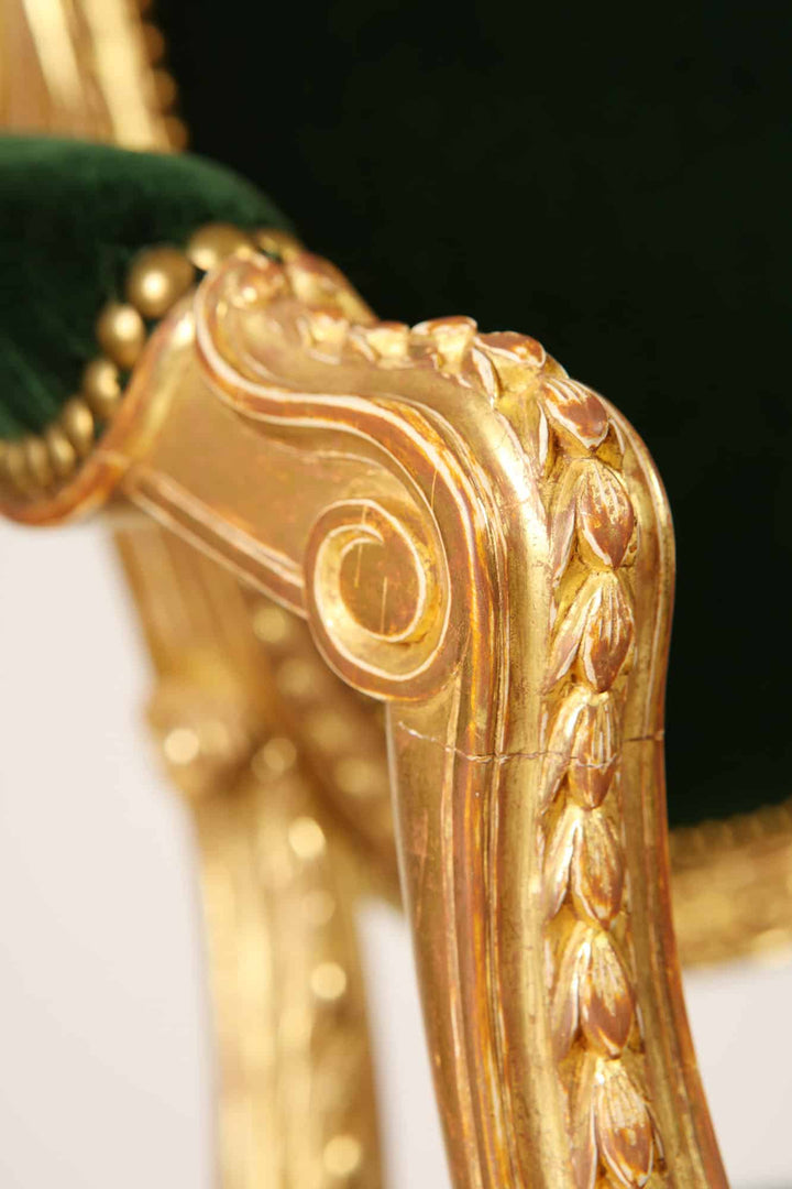 Close-up of ornate gilded wood armrest on George III armchair with green velvet upholstery by Collection CK20.