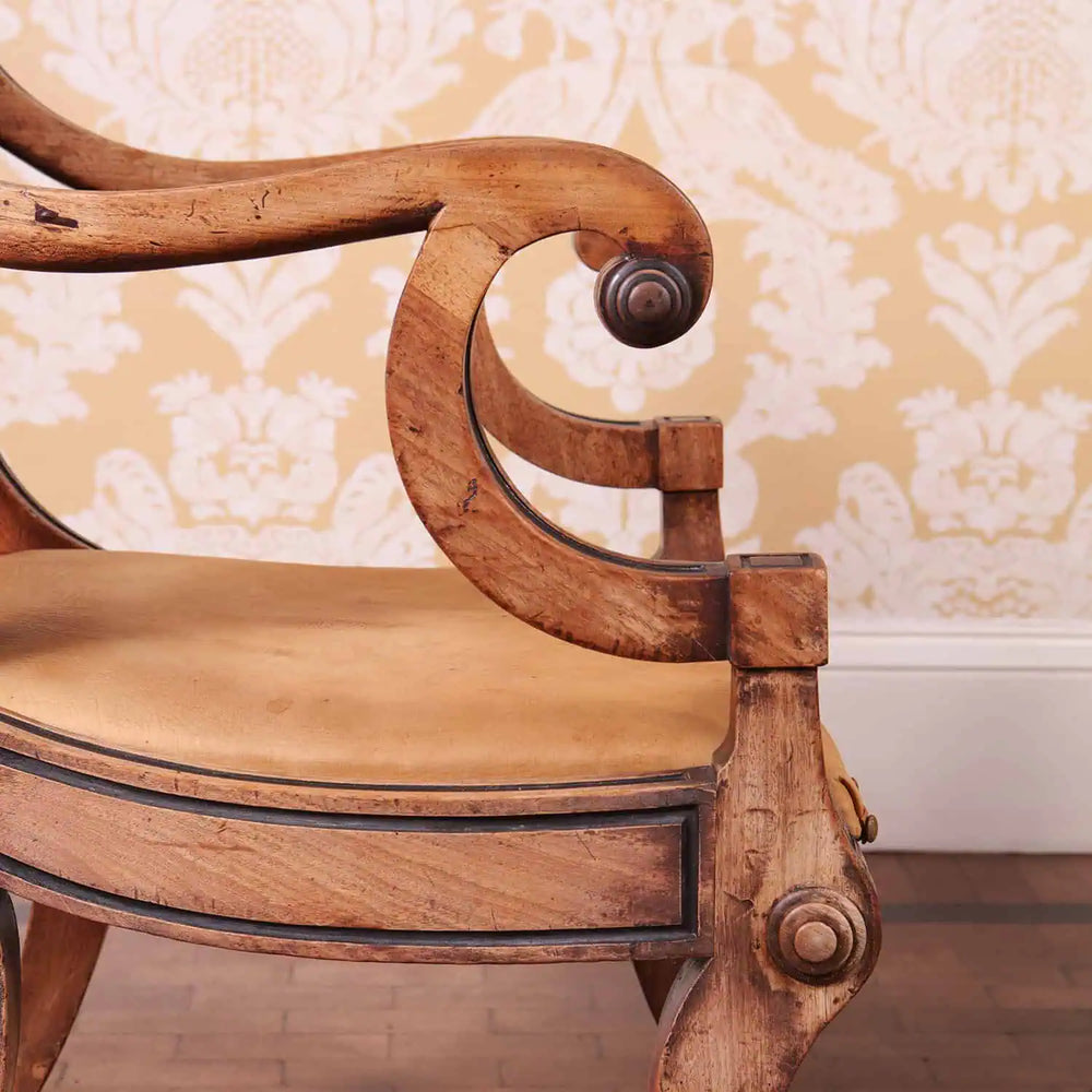Detailed close-up of a Regency armchair's elegant wooden armrest with black inlay from Collection PK10