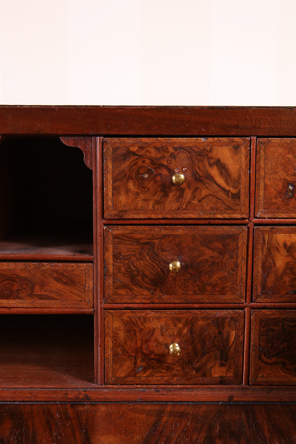 Close-up of burr walnut drawers with brass knobs on George I bureau by Nwtiques