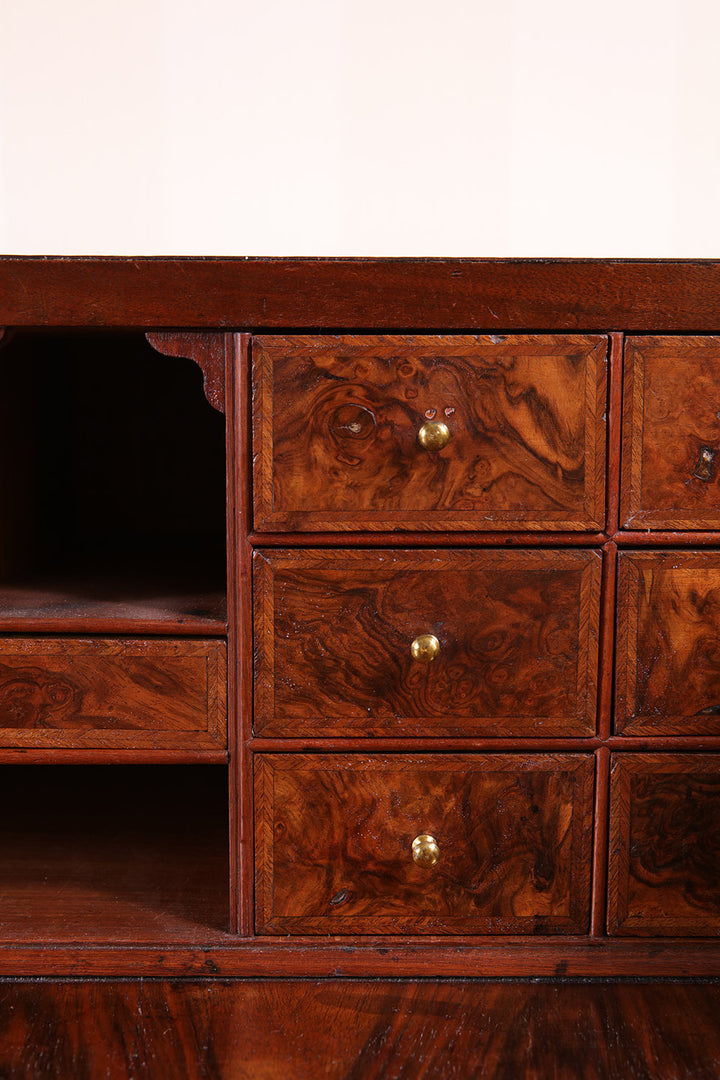 Close-up of burr walnut drawers with brass knobs on George I bureau by Nwtiques