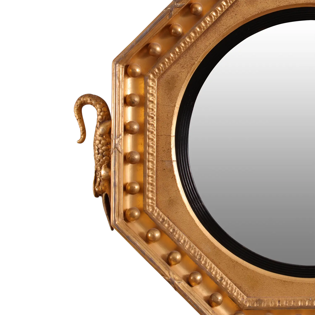 Rare Early 19th Century Regency Octagonal Convex Mirror with giltwood frame and intricate carved details.