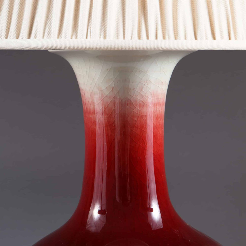 Chinese Sang de Boeuf Vase mounted as a table lamp with red glaze and cream pleated lampshade, circa 1980.