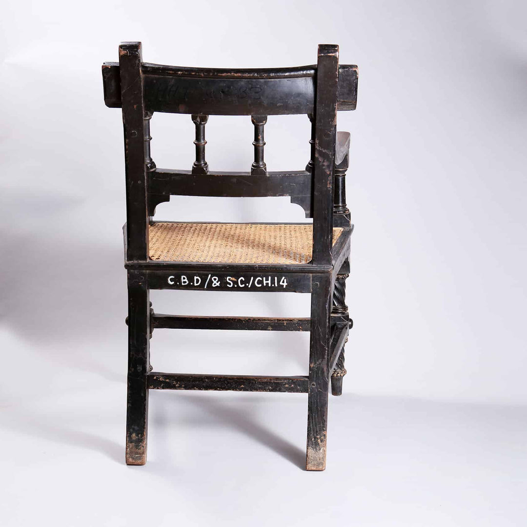 Pair of antique Indian Bombay Gothic armchairs with cane seats and detailed dark wood frames by Collection EE30