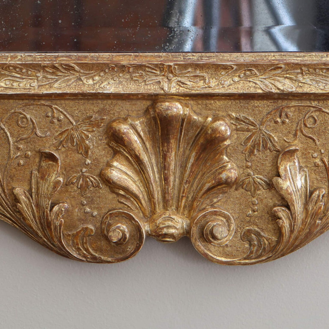 George II gesso Girandole Wall Mirror with intricate gilt gesso foliage carvings and shaped moulded frame detail.