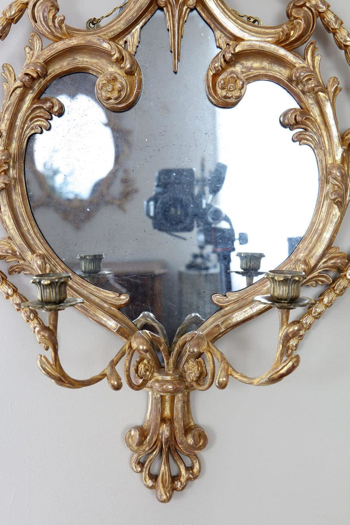 A fine pair of giltwood girandoles English 19th Century in the manner of William France with ornate gold frames and candle holders