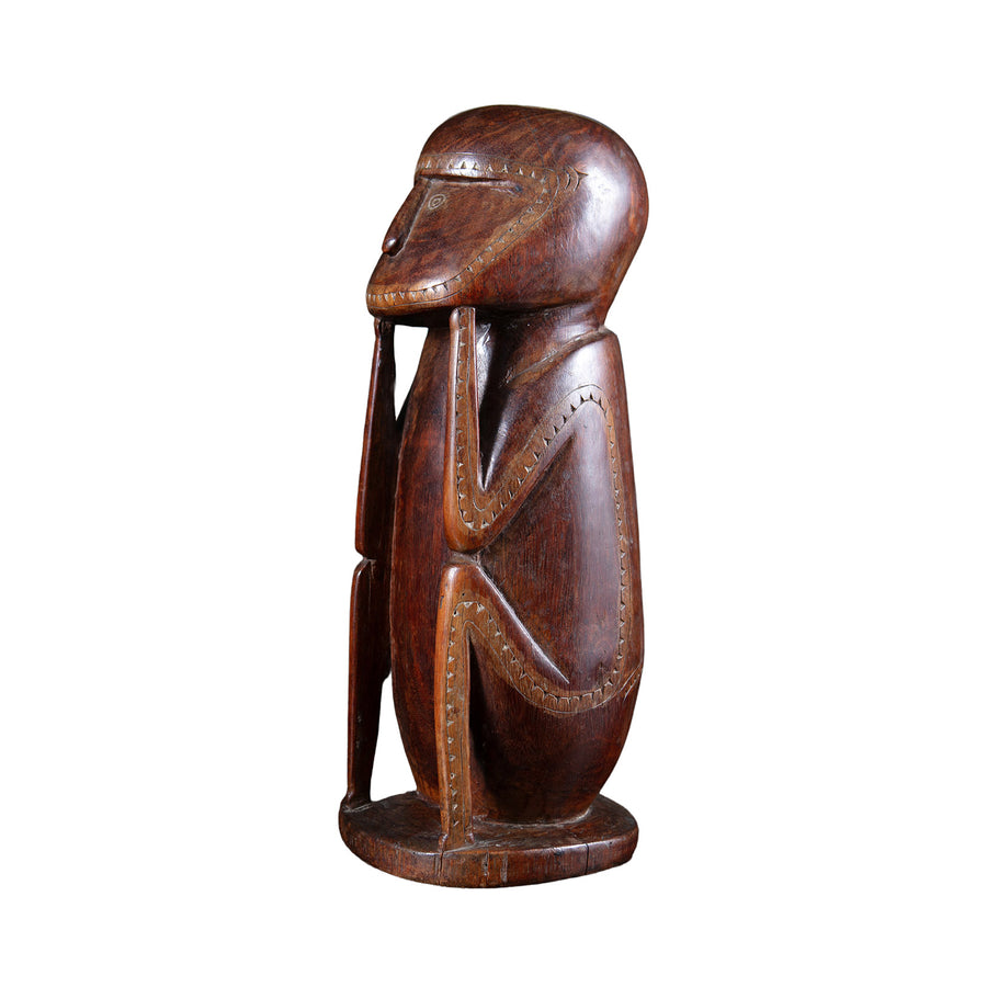 Carved seated Massim protective figure with lime inlay from Collection ON10, showcasing Oceanic craftsmanship.