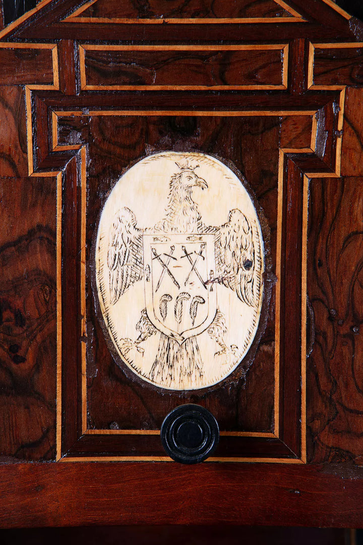 Close-up of inlaid eagle and coat of arms detail on 17th century Spanish walnut Vargueno by Nwtiques