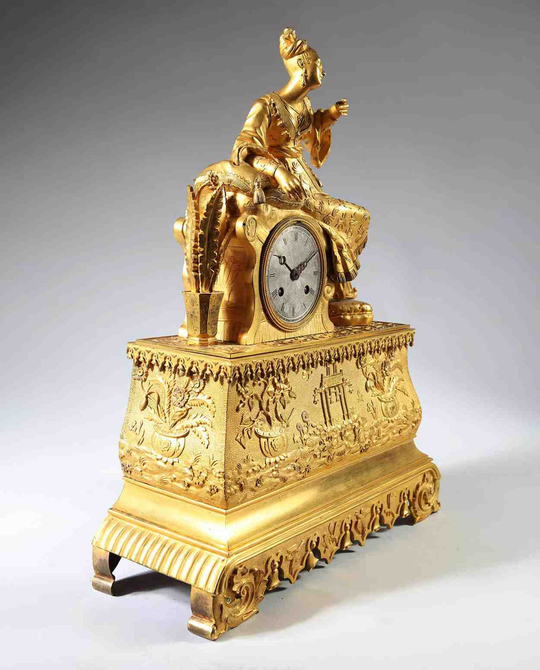 19th-century gilt bronze Ottoman mantle clock with seated lady, intricate design by Nwtiques