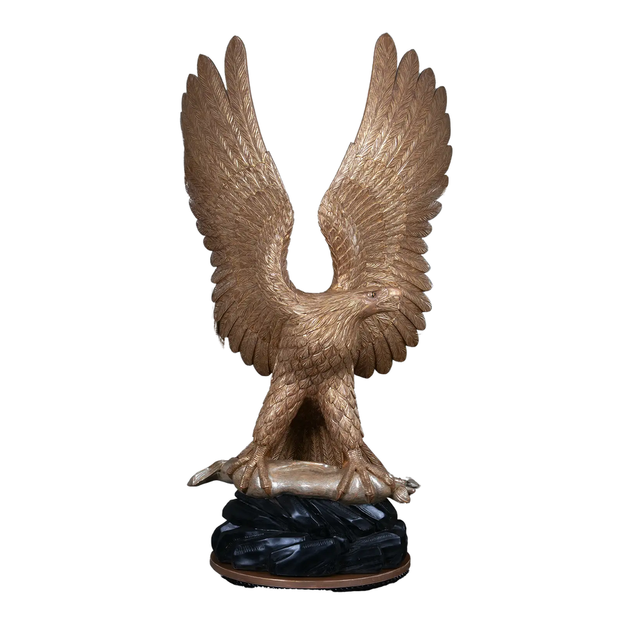 Carved Giltwood Eagle & Ebonised Column with wings spread, holding a silver hare, perched on ebonised rocks.