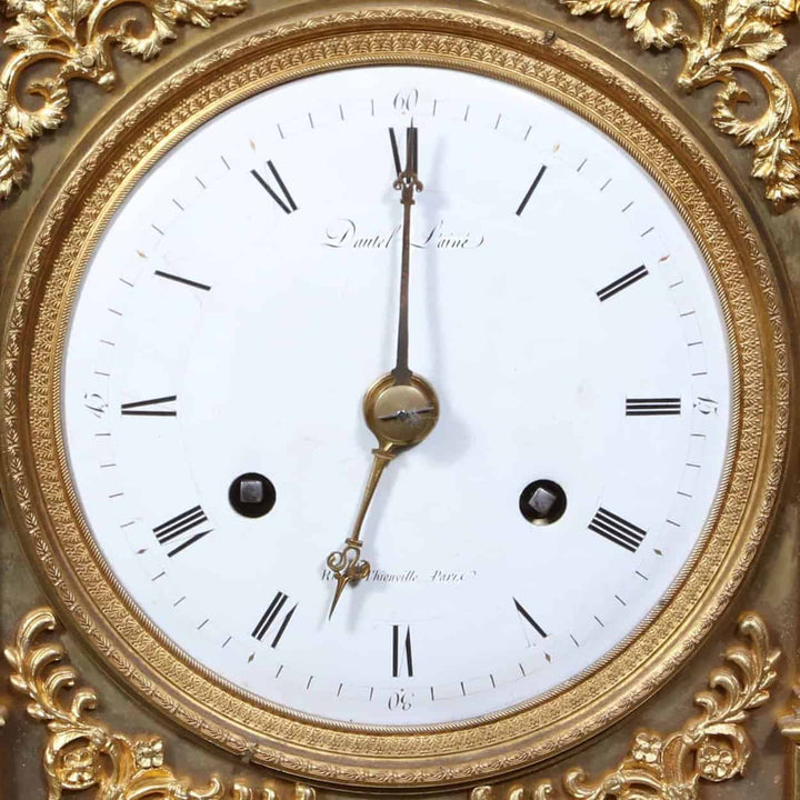 Close-up of a white enamel dial with Roman numerals on a Dautel mantle clock from Nwtiques