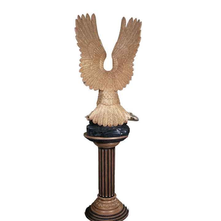 Carved Giltwood Eagle & Ebonised Column featuring a gilded eagle with wings spread on a decorative column stand.