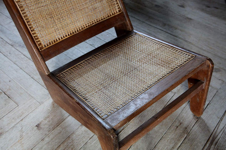 Vintage Kangaroo Chandigarh Chair with teak frame and woven cane seat from Collection EE30 on wooden floor