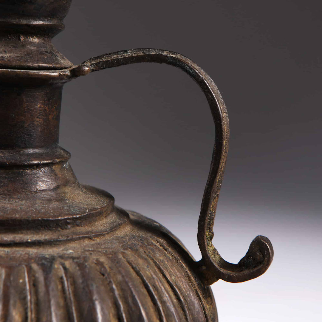Close-up of an antique Mughal Bronze Rosewater Sprinkler handle from Collection EE20 with decorative gadrooned body detail