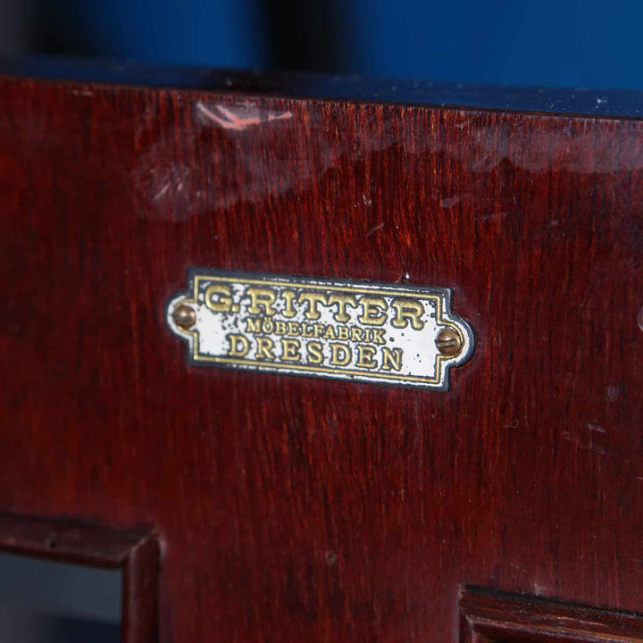 Close-up of G. Ritter Dresden maker’s mark on dark wood German Secessionist cabinet by Collection EE40