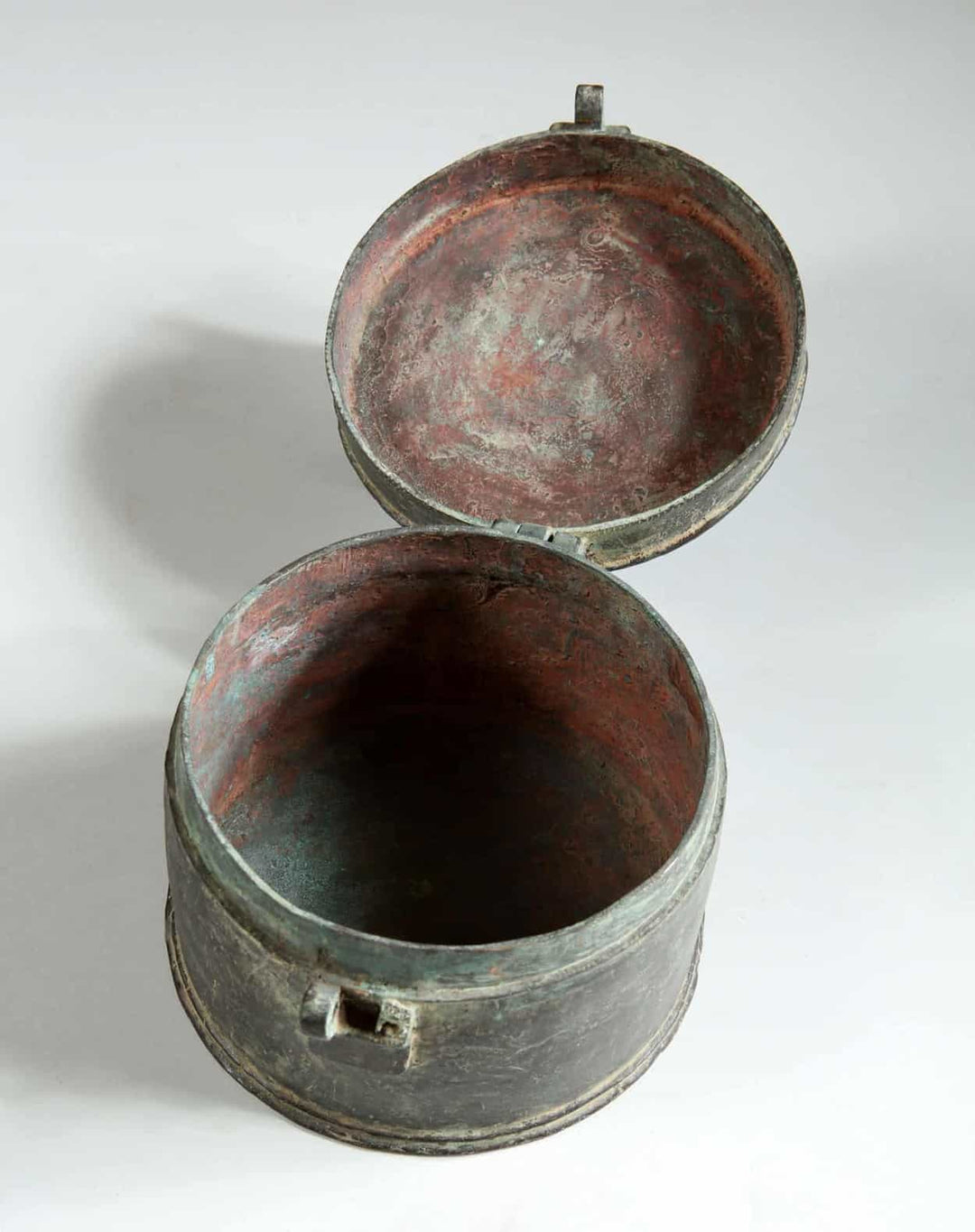 Open 19th century Indian circular bronze box with hinged lid from Collection EE10 displayed on white background