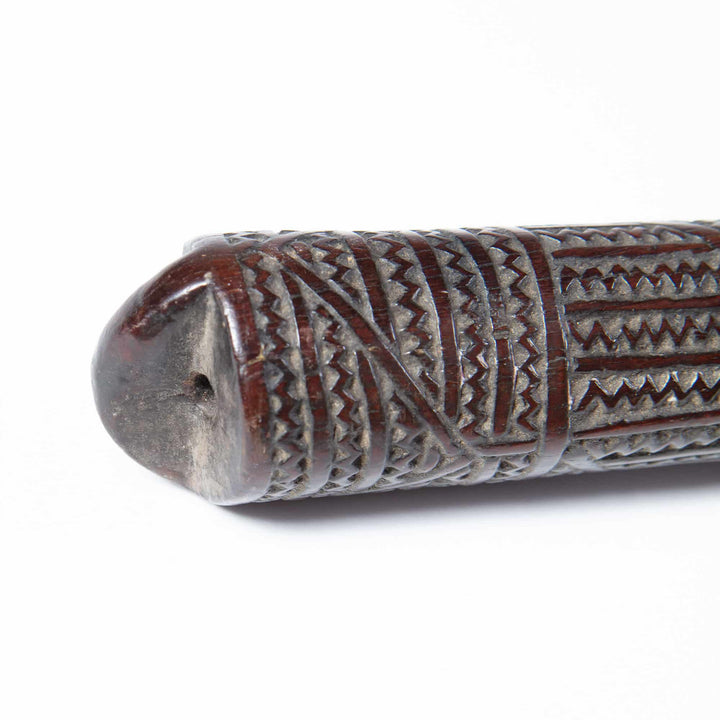 Close-up of a carved 19th-century Tongan ironwood war club handle from Collection ON10 showing detailed geometric patterns