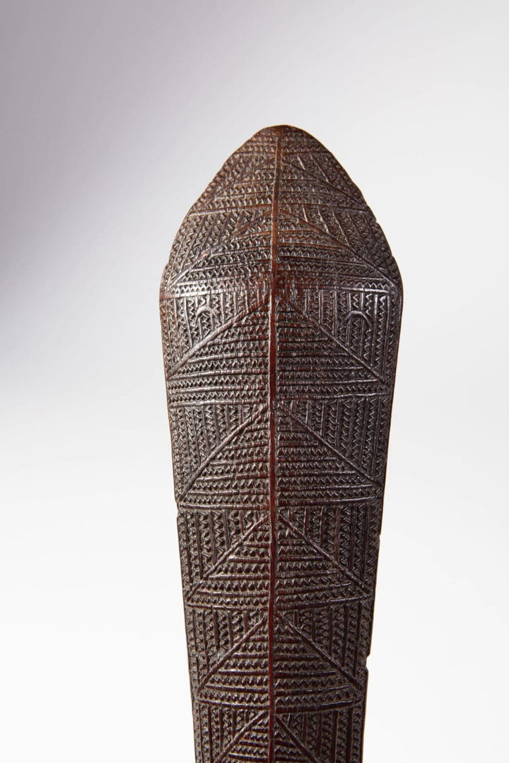 Close-up of intricately carved Tongan ironwood war club from Collection ON10 showcasing native artisanship details