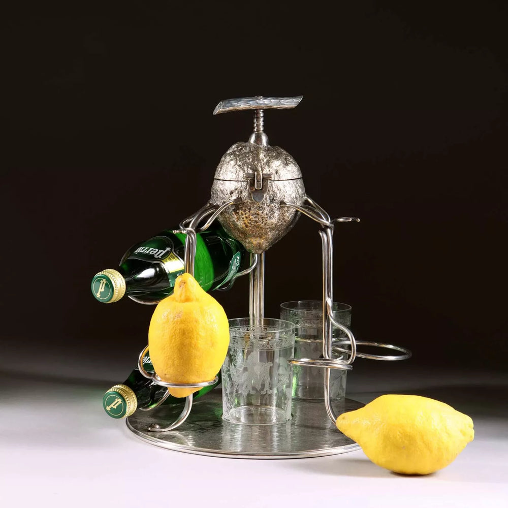 Hukin and Heath silver plate lemon squeezer with bottles and glasses on silvered dish stand by The Sold Archive