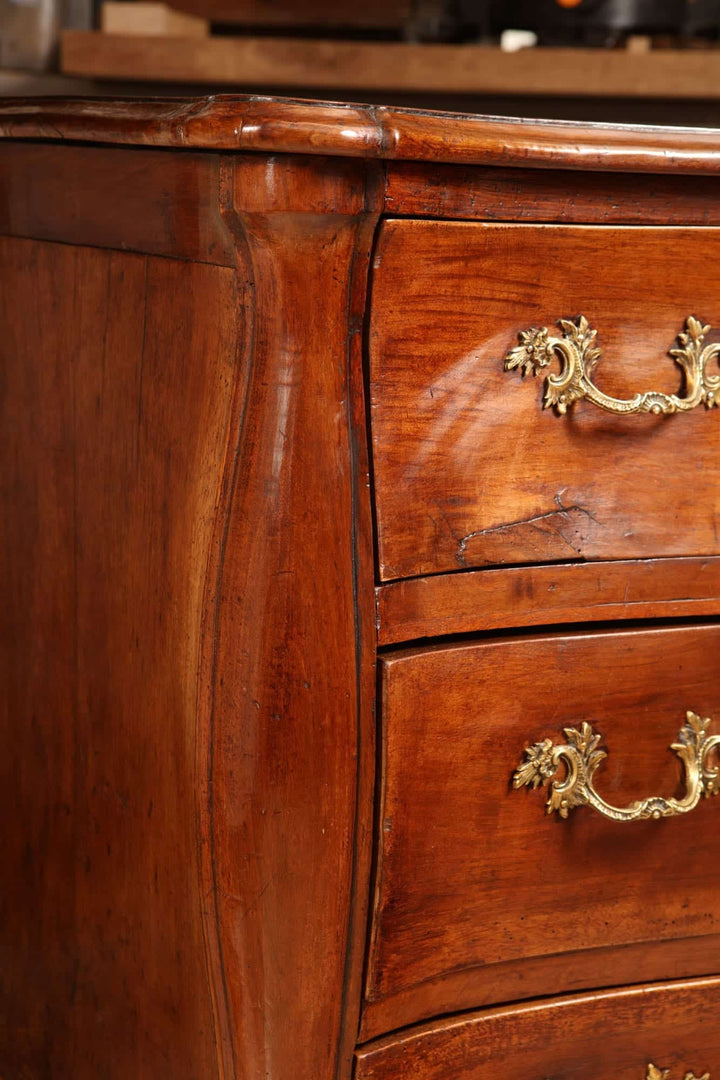 Close-up of a Louis XV walnut commode with ornate handles by Nwtiques, mid 18th century France