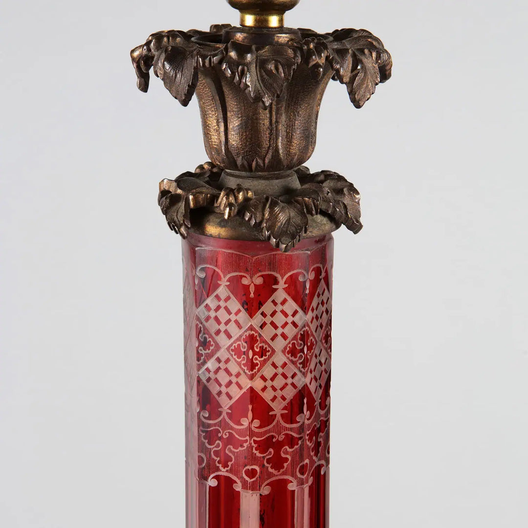 Large Bohemian Engraved Red Glass Table Lamp with brass foliate capital and intricate vine and grape base details.