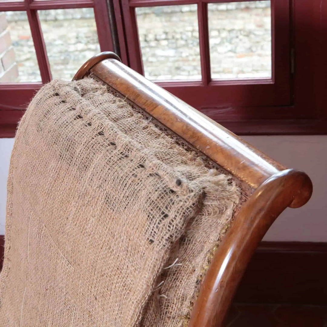 Close-up of William IV walnut library chair backrest showing original upholstery and polished wood frame by Collection EE30
