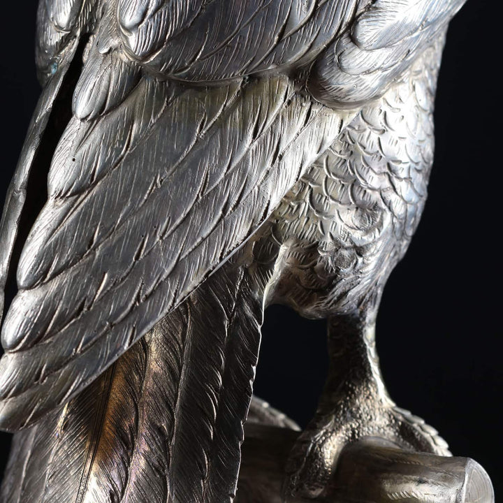 Close-up detail of solid silver perched hawk sculpture showcasing feather texture by Collection CK20