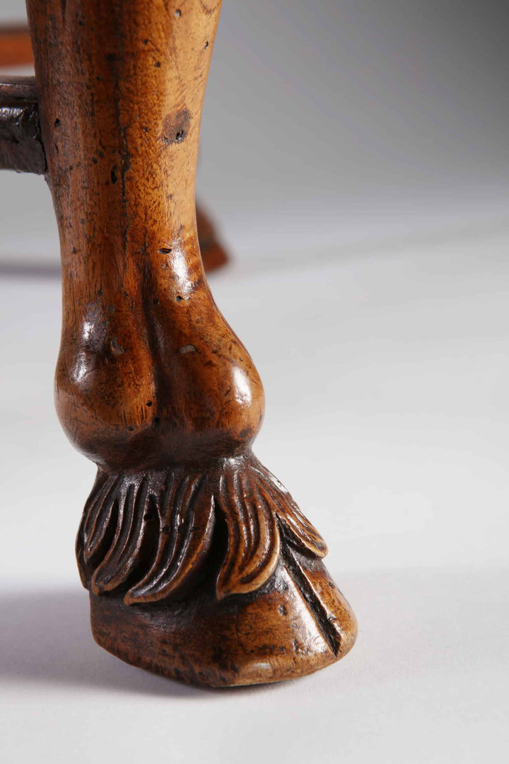 Close-up of detailed carved hairy hoof foot on 18th century Italian walnut stool by Collection CK20