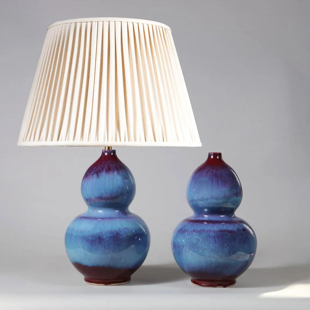 Pair of Flambe Double Gourd Vases as Table Lamps with blue glaze and cream pleated shade on one vase.