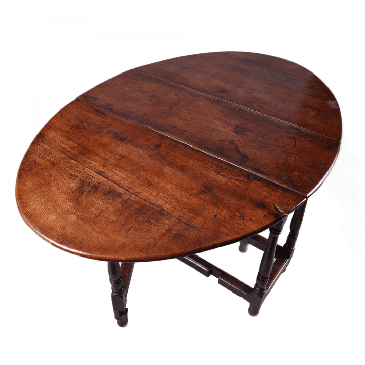 17th Century Oak drop leaf table with turned legs and stretchers, oval top in rich oak wood finish.