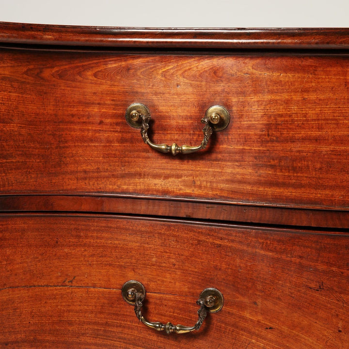 Close-up of mahogany George III serpentine chest drawers with gilt brass handles by Collection CK20