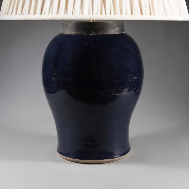 Chinese Monochrome Blue Table Lamp featuring a 19th century bulbous blue vase with metal collar and fabric shade.