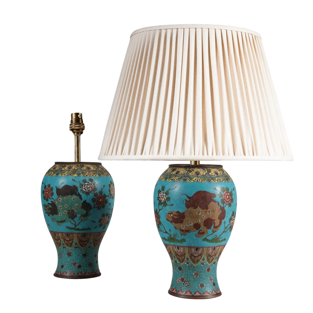 Pair of Chinese Cloissoné Lamps with foo dog designs in green and brown on a blue floral enamel ground circa 1870.